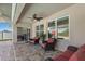Covered patio featuring comfortable seating, ceiling fans, and a view of the backyard and pool at 5759 Marsh Landing Dr, Winter Haven, FL 33881
