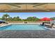 Backyard swimming pool with lounge chairs, umbrella, and clear water, providing a relaxing oasis at 5759 Marsh Landing Dr, Winter Haven, FL 33881