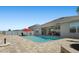 A gorgeous backyard pool featuring a brick-paved deck, lounge chairs, and a red umbrella for shade at 5759 Marsh Landing Dr, Winter Haven, FL 33881