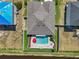 Aerial view of a backyard with a sparkling pool, patio area, and well-maintained landscaping with fencing at 5759 Marsh Landing Dr, Winter Haven, FL 33881
