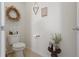 Cozy powder room with neutral decor and a classic toilet at 5759 Marsh Landing Dr, Winter Haven, FL 33881