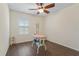 Bright room with wood-look flooring, ample space, and a window for natural light, perfect for various activities at 5759 Marsh Landing Dr, Winter Haven, FL 33881