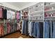Spacious walk-in closet with custom shelves and wood floor, perfect for organizing your wardrobe at 5759 Marsh Landing Dr, Winter Haven, FL 33881