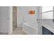 Bright bathroom featuring a soaking tub, glass shower, and white vanity at 577 Eagle Pointe S, Kissimmee, FL 34746