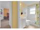 A full bathroom featuring a lemon shower curtain, white cabinet, and tiled bath at 577 Eagle Pointe S, Kissimmee, FL 34746