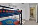 A bedroom featuring a bunkbed and blue and orange sport themed decor at 577 Eagle Pointe S, Kissimmee, FL 34746