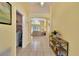 Welcoming hallway featuring tile flooring and an open view to the main living area and laundry at 577 Eagle Pointe S, Kissimmee, FL 34746