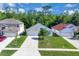Charming home with lush front lawn, driveway, and beautiful landscaping at 577 Eagle Pointe S, Kissimmee, FL 34746