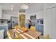 Well-lit kitchen with stainless steel appliances, mosaic backsplash, and blue and white cabinets at 577 Eagle Pointe S, Kissimmee, FL 34746