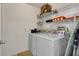 A laundry room featuring a washer and dryer and a shelf at 577 Eagle Pointe S, Kissimmee, FL 34746