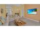 Spacious living room with modern decor, neutral walls, and tile flooring in the dining area at 577 Eagle Pointe S, Kissimmee, FL 34746