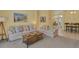 Open-concept living room with tile flooring, neutral walls, modern furniture, and ample natural light at 577 Eagle Pointe S, Kissimmee, FL 34746