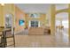 Open living space featuring neutral color scheme, large windows, and combination carpet and tile flooring at 577 Eagle Pointe S, Kissimmee, FL 34746