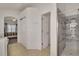 Bright main bathroom with a glass shower, dual closets, and entrance to the main bedroom at 577 Eagle Pointe S, Kissimmee, FL 34746