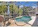 Inviting screened-in pool area with outdoor seating, perfect for relaxation and entertaining at 577 Eagle Pointe S, Kissimmee, FL 34746