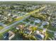 Aerial view of neighborhood with mature trees, streets and various home styles at 638 Kangaroo Dr, Poinciana, FL 34759
