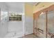 Bathroom featuring tiled shower, window, and partial demolition to reveal plumbing work to be completed at 638 Kangaroo Dr, Poinciana, FL 34759