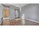 A bedroom with gray walls and wood-look flooring, featuring a closet with mirrored doors at 638 Kangaroo Dr, Poinciana, FL 34759