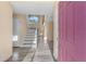 Bright foyer with neutral walls, wood-look flooring, and a staircase leading to the upper level at 638 Kangaroo Dr, Poinciana, FL 34759