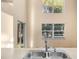 Kitchen sink with double windows in a home with neutral paint and wood-look flooring at 638 Kangaroo Dr, Poinciana, FL 34759
