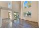 Large living space features tall ceilings, neutral paint and wood-look flooring with pool views at 638 Kangaroo Dr, Poinciana, FL 34759