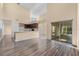 Open-concept living area with wood-look floors, neutral color palette, and kitchen pass-through at 638 Kangaroo Dr, Poinciana, FL 34759