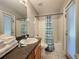 Bright bathroom features a shower-tub combination, granite countertop and access to the backyard at 661 Sandy Ridge Dr, Davenport, FL 33896