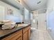 Bathroom vanity with a stack of white towels next to walk-in shower at 661 Sandy Ridge Dr, Davenport, FL 33896