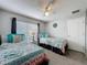 Bedroom with carpeted floors, ceiling fan, and 2 twin beds with decorative pillows at 661 Sandy Ridge Dr, Davenport, FL 33896