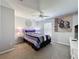 Cozy bedroom featuring carpet, a ceiling fan, and decoratively painted walls at 661 Sandy Ridge Dr, Davenport, FL 33896