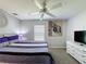 Bedroom featuring carpet, ceiling fan, white dresser and colorful abstract art at 661 Sandy Ridge Dr, Davenport, FL 33896