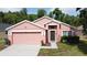Charming single-story home features a two-car garage and well-manicured lawn at 661 Sandy Ridge Dr, Davenport, FL 33896
