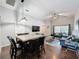 Open-concept living area with vaulted ceilings, wood floors, and comfortable seating at 661 Sandy Ridge Dr, Davenport, FL 33896