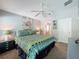 This primary bedroom offers a ceiling fan and easy access to an ensuite bathroom at 661 Sandy Ridge Dr, Davenport, FL 33896