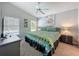 This main bedroom features a queen bed, ceiling fan, and dresser at 661 Sandy Ridge Dr, Davenport, FL 33896