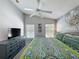 This main bedroom has an abundance of natural light from the windows and a ceiling fan at 661 Sandy Ridge Dr, Davenport, FL 33896