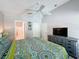 This main bedroom has a ceiling fan, view of the backyard, and attached bathroom at 661 Sandy Ridge Dr, Davenport, FL 33896