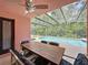 Covered patio with dining set overlooking a screened-in pool at 661 Sandy Ridge Dr, Davenport, FL 33896