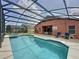 Inviting screened-in pool area with ample seating and a sparkling pool at 661 Sandy Ridge Dr, Davenport, FL 33896