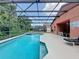 Inviting screened-in pool area with ample seating and a sparkling pool at 661 Sandy Ridge Dr, Davenport, FL 33896
