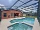 Enjoy a great outdoor space with screened in pool, spa, and outdoor dining at 661 Sandy Ridge Dr, Davenport, FL 33896