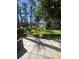 Backyard patio with green lawn area leading to trees, foliage and view of a lake at 664 Lake Villas Dr, Altamonte Springs, FL 32701