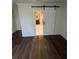 Bedroom features hardwood floors and a sliding barn door leading to the bathroom at 664 Lake Villas Dr, Altamonte Springs, FL 32701