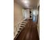 Hallway featuring hardwood floors and a stacked washer and dryer behind a sliding barn door at 664 Lake Villas Dr, Altamonte Springs, FL 32701