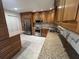 Well-lit kitchen featuring stainless steel appliances, granite countertops, and custom wood cabinetry at 664 Lake Villas Dr, Altamonte Springs, FL 32701