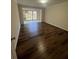 Open-concept living room features hardwood floors, neutral walls, and bright light from large window at 664 Lake Villas Dr, Altamonte Springs, FL 32701