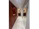 Walk-in closet and hallway with mirrored closet doors leads to a bathroom with lighted mirror at 664 Lake Villas Dr, Altamonte Springs, FL 32701