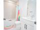 Bright bathroom with a tub and colorful rainbow-themed accessories at 6953 Broglie St, Orlando, FL 32827