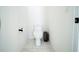 Powder room with a toilet, a waste can, and a toilet paper holder at 6953 Broglie St, Orlando, FL 32827