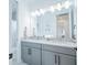 Spacious bathroom with double vanity sinks, modern lighting, and a walk-in shower at 6953 Broglie St, Orlando, FL 32827